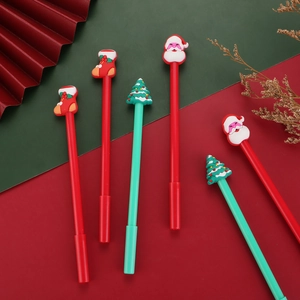 Creative Christmas gel pens with Santa and Christmas tree toppers on festive background