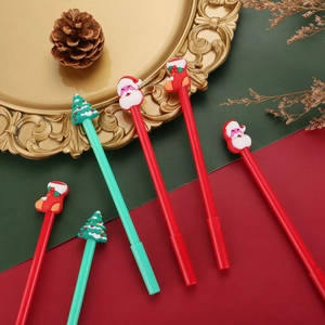 Detail of Christmas gel pens featuring Santa, tree, and sock silicone toppers on a tray