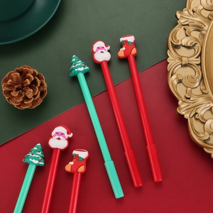 Detailed view of six Christmas gel pens with Santa, tree, and sock silicone toppers