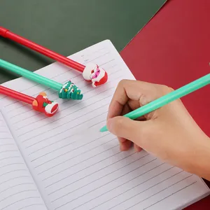 Detailed view of hand writing with Santa Claus and Christmas tree themed gel ink pens