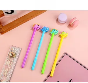 Set of four colorful dinosaur gel pens in purple blue green and yellow on pink background