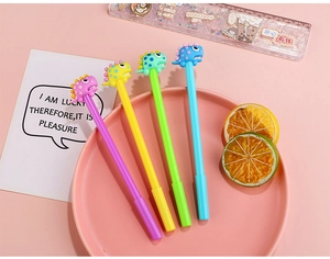 Detail of four colorful dinosaur gel pens with 3D silicone caps in a creative gift set