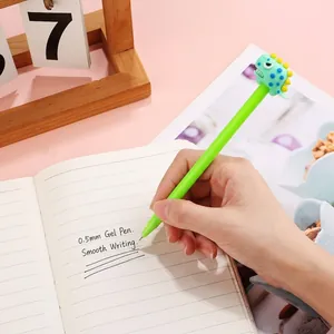 Green cartoon dinosaur 0.5mm gel pen writing on notebook for student stationery