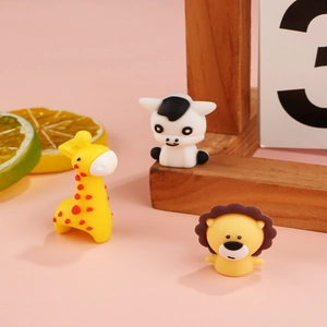Detail of cute silicone cartoon lion, giraffe and cow animal cable protector accessories