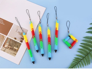 Detail of colorful building block pens with black lanyards on light blue background