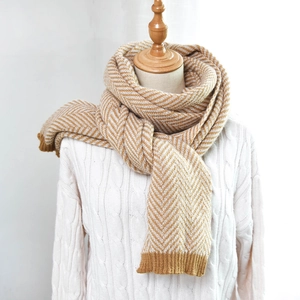 Thick mustard yellow herringbone knit scarf for winter shown on a mannequin model