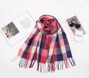 Flat lay of red and blue plaid scarf with fringes and stylish fashion accessories