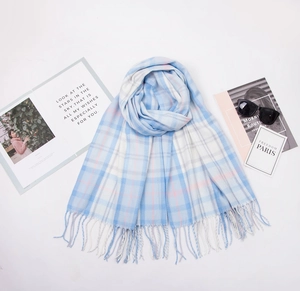 Detail of plaid scarf fringe with light blue check pattern and stylish accessories