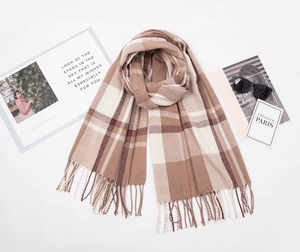 Detailed view of soft cashmere-like plaid scarf with fringe trim and check pattern