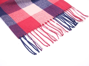 Detailed close-up of red and navy plaid scarf with soft cashmere-like texture and fringe