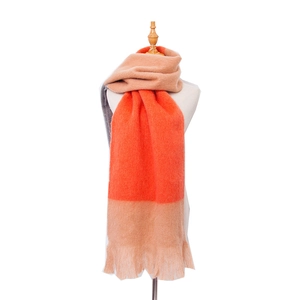 Detail of soft striped scarf with orange, beige, and grey color blocks and fringe trim