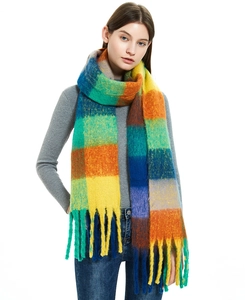 Close-up of rainbow plaid scarf with thick long tassels in soft mohair texture