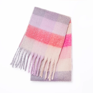 Macro detail of thick rainbow checkered mohair scarf featuring long woven tassels