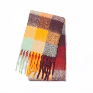 Detail of colorful rainbow plaid mohair scarf showing soft texture and long tassels