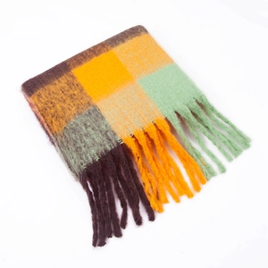 Close-up of thick winter rainbow plaid scarf featuring long chunky fringe tassels
