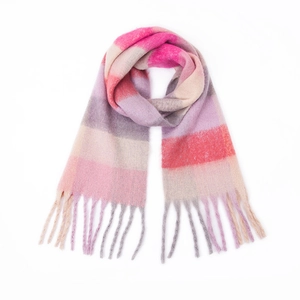 Close-up of soft thick mohair scarf featuring colorful rainbow stripes and long tassels