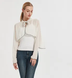 Detail of white chiffon sun protection shawl with bow tie neckline and black hem stitch