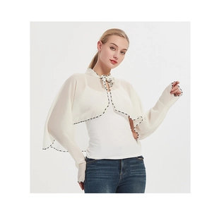 Detail of off-white chiffon sun protection shawl with floral trim and bow tie neckline