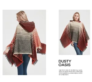 Detail of hooded knit poncho showing gradient herringbone pattern and fringe tassels