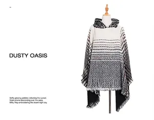 Detail of hooded poncho featuring striped herringbone tweed fabric and fringed edges