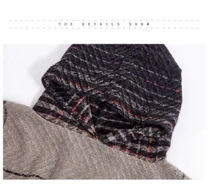 Detail of hooded poncho showing gray herringbone knit fabric with colorful thread accents