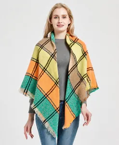 Close-up of thick plaid shawl with tassels in yellow, red and green knit pattern