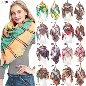 Detail view of large checkered scarves with fringe edges in eight colorful patterns