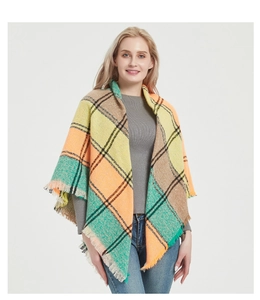 Detail of soft checkered scarf with yellow, orange and green plaid and fringe edges