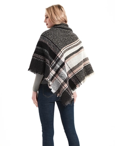 Detail of herringbone pattern and natural fringe on a triangular knit shawl scarf