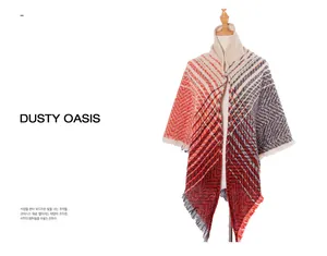 Detail of chevron pattern knit shawl with tassels in coral, beige and navy blue colors