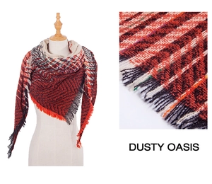 Detail of red and black herringbone knit scarf with fringe edge and geometric plaid pattern
