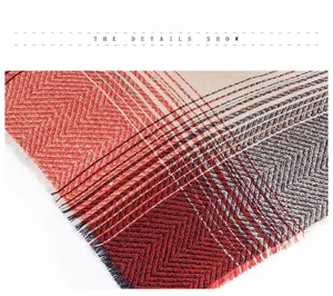 Macro view of chevron pattern knit scarf with fringe in red, grey and beige tones