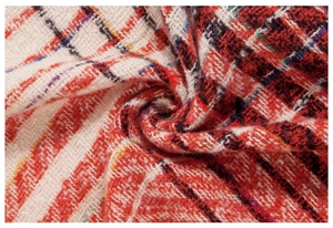 Detailed close-up of thick herringbone weave pattern in red, black, and purple fabric