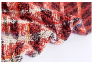 Close-up of red and black herringbone knit texture on a soft triangular shawl scarf