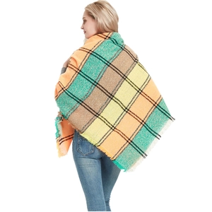 Thick plaid winter shawl with orange and green patterns featuring elegant fringe edges
