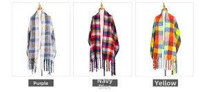 Detail of colorful plaid scarves with thick tassels in purple, navy red and bright yellow