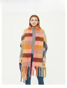 Close-up of thick multi-color plaid scarf with long tassels and chunky knit texture