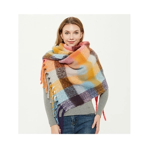 Close-up of thick multi-color plaid scarf featuring soft brushed texture and long fringe