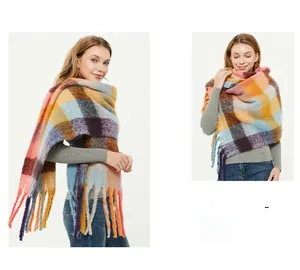 Detail of colorful plaid scarf with chunky tassel fringe and soft brushed knit texture