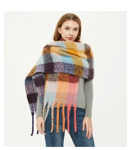 Close-up of thick colorful checkered scarf featuring long tassels and soft fuzzy texture