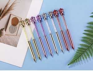 Close-up of elegant crown crystal ballpoint pens in multiple metallic colors with rhinestones