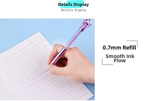 Close-up of hand holding a purple crystal crown pen with a 0.7mm fine nib point