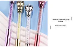Detail of elegant ballpoint pens with crown top and colorful crystal filled barrels