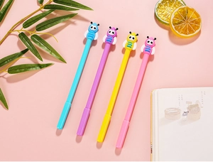 Detailed view of colorful cartoon bee pens arranged neatly on a soft pink background