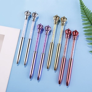 Chic crown crystal ballpoint pens in silver, gold, and purple on a light blue background
