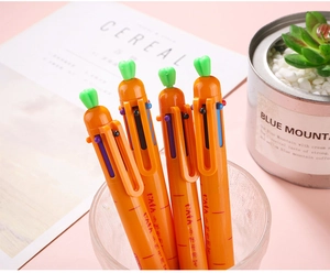 Macro detail of cute 6-color carrot retractable ballpoint pens in a glass cup