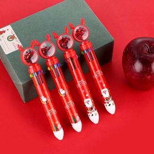 Close-up of four Christmas 10-color pens with glitter deer topper on a green gift box