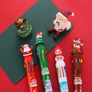 Detail of Christmas multi-color ballpoint pens with festive silicone cartoon toppers