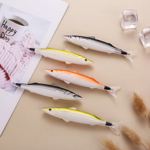 Five creative fish-shaped ballpoint pens in realistic colors on a minimalist desk setup