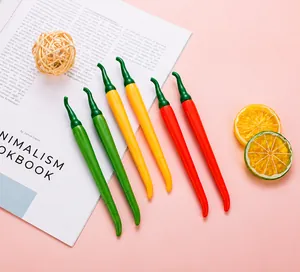 Creative pepper-shaped pens in red, green, and orange colors on a pink backdrop